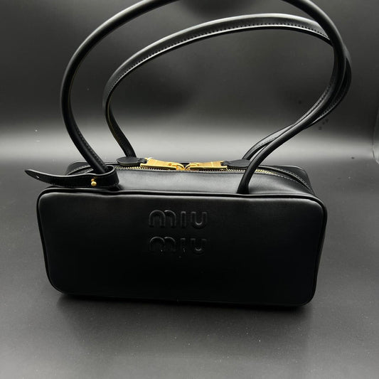 Black leather Miu Miu bag with gold hardware